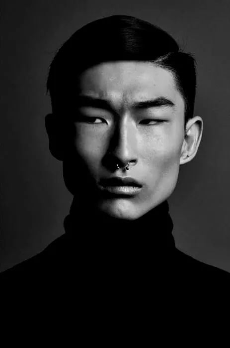 High-contrast black and white portrait photograph, photographic, minimal, dark