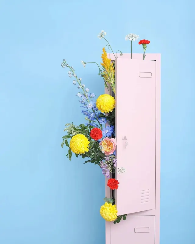 Flower-draped pink locker against blue background, playful, colorful, vibrant