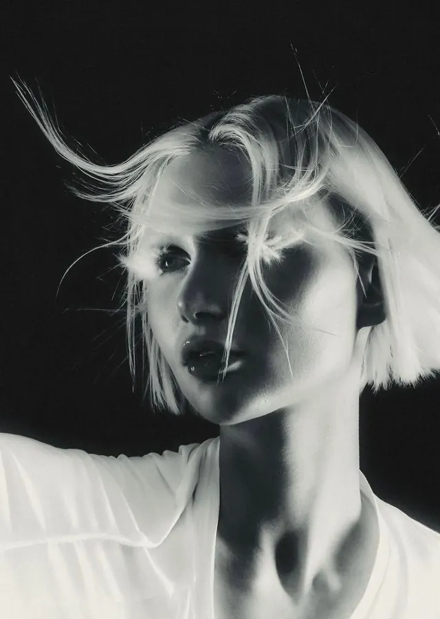 Artistic black and white portrait with hair in motion, photographic, portrait, vibrant