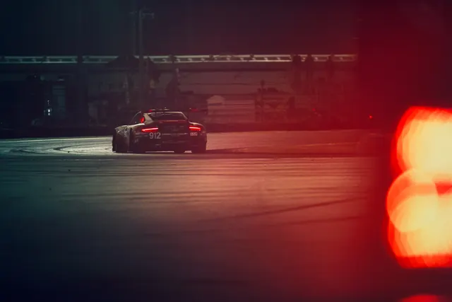 Cinematic sports car in industrial garage with dramatic lighting, photographic, cinematic, vibrant