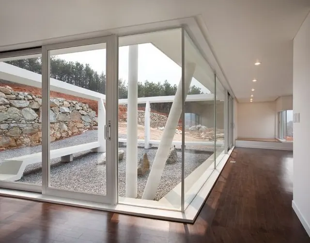 Modern interior with large windows overlooking garden landscape, photographic, minimalist, warm