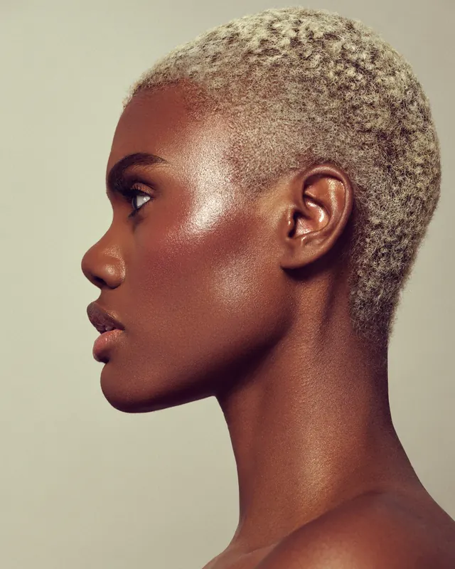 Minimal profile portrait of woman with short hair, photographic, minimal, warm