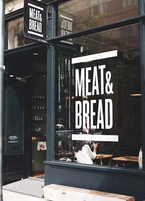 Meat & Bread storefront signage, corporate-clean, minimal, high-contrast