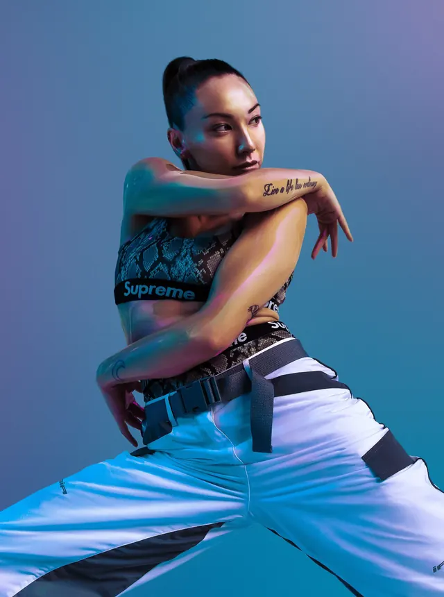 Portrait of a person with tattoos and blue lighting