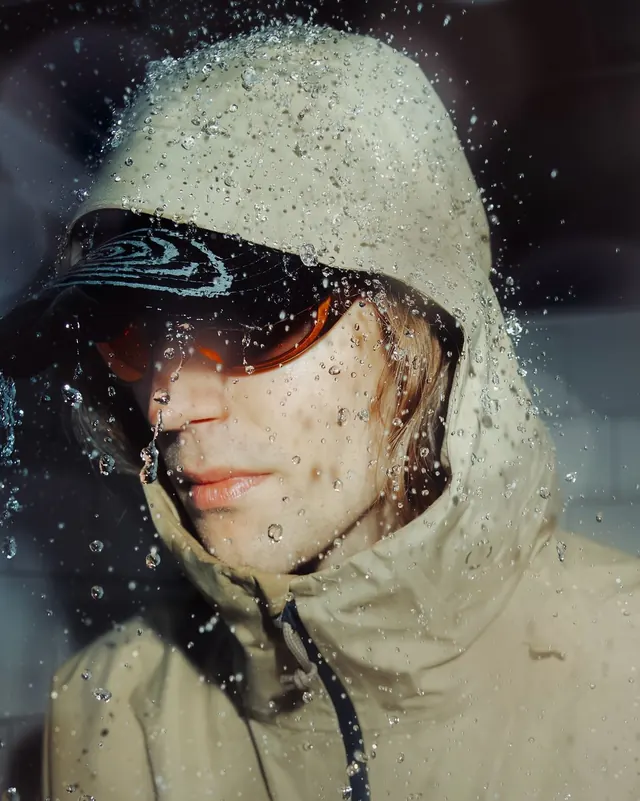 Wet beauty portrait with color contrast, photographic, editorial, dark