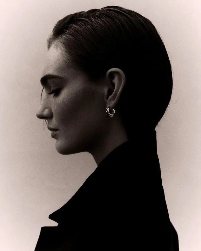 Profile portrait with earring detail, minimal, photographic, monochrome