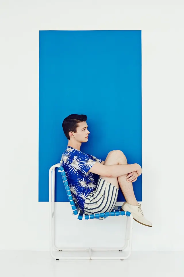 Fashion photography with bold blue backdrop, photographic, editorial, vibrant