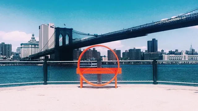 Brooklyn Bridge urban landscape with red geometric installation, photographic, minimal, cool