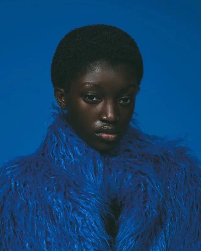Woman in blue shaggy fur coat, photographic, minimal, vibrant