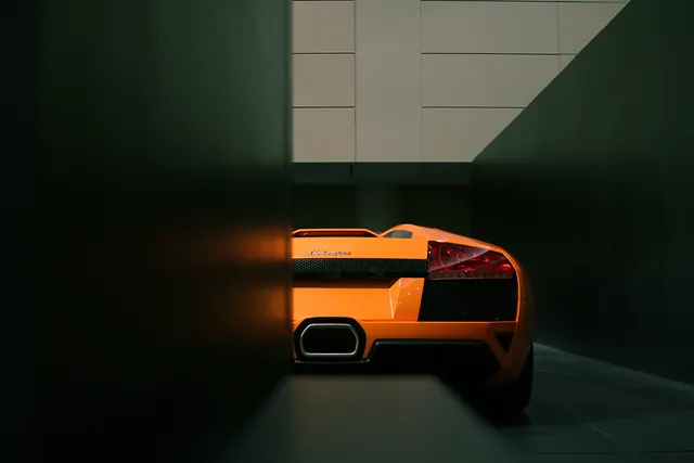 Orange Sports Car in Dark Tunnel
