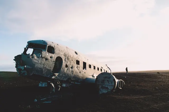 Abandoned aircraft fuselage in desolate landscape, photographic, editorial, light