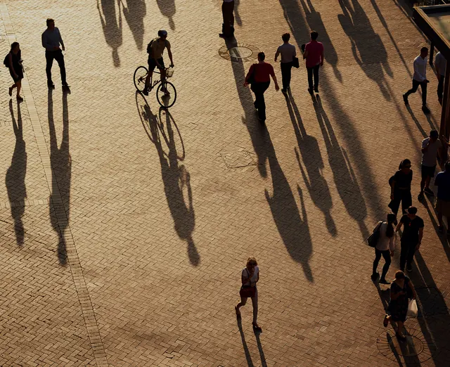 People on Sand with Long Shadows