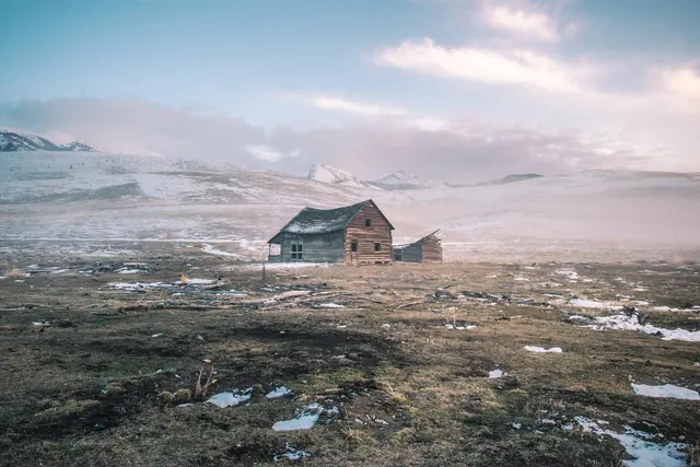Remote Cabin in Snowy Landscape