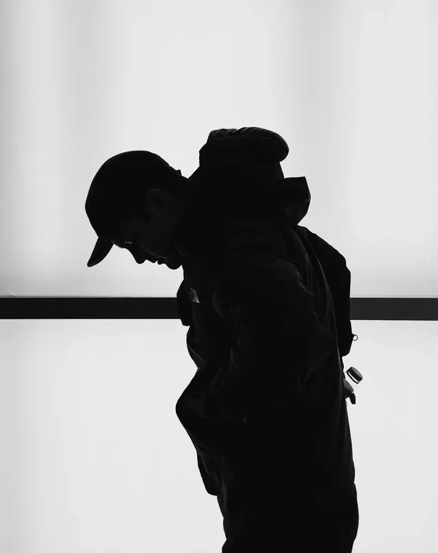 Silhouette of Person in Hoodie