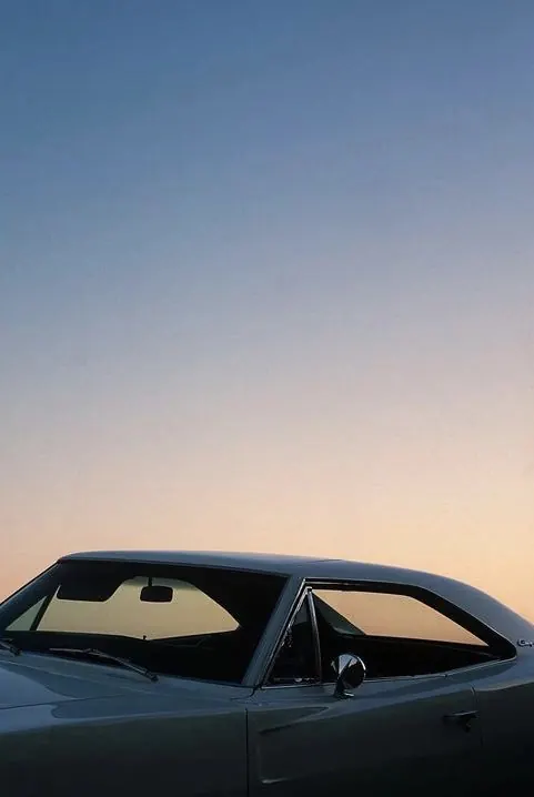 Vintage Car Silhouette against Gradient Sky