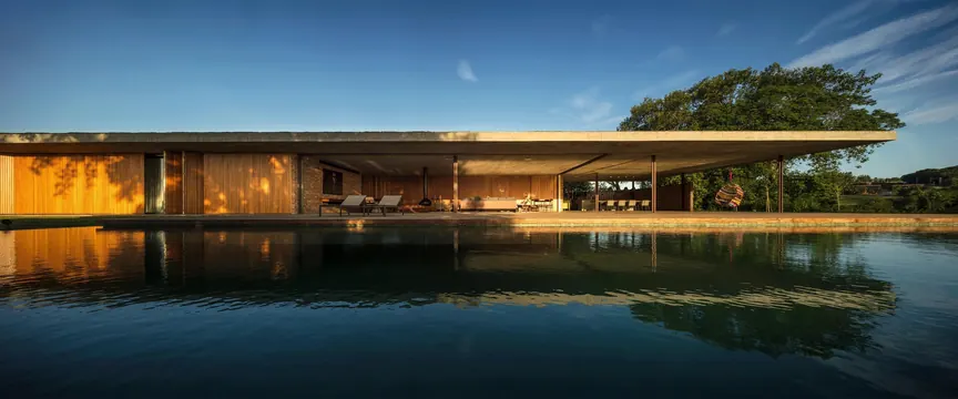 Minimalist residential pavilion reflected in water, architectural, minimalist, warm