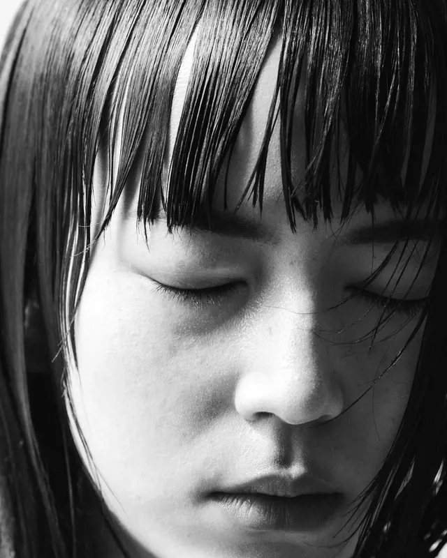 Black and white portrait with dramatic bangs, photographic, minimalist, monochrome