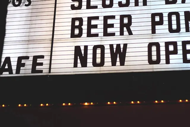 Movie theater marquee signage, photographic, technical, dark