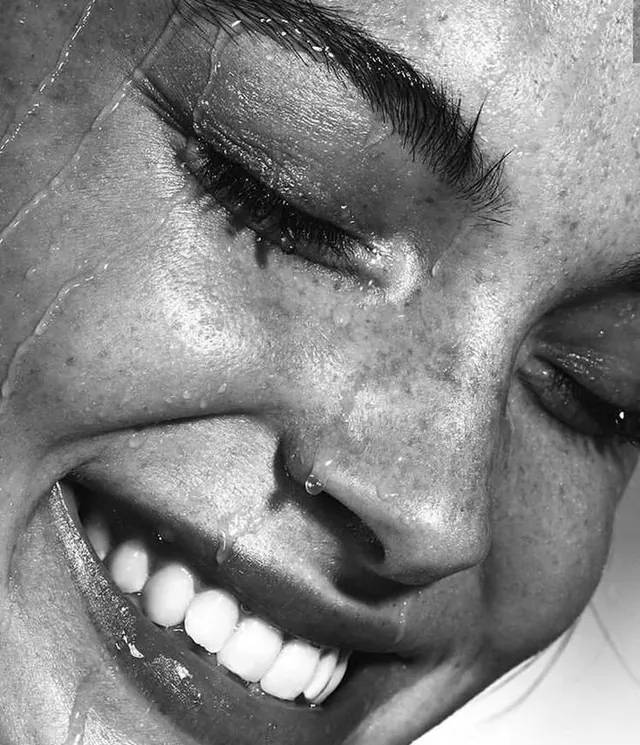 Close-up smile portrait in black and white, photographic, monochrome