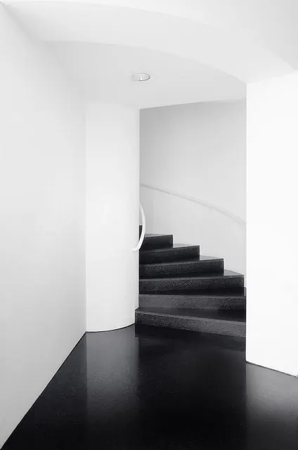 Minimalist spiral staircase architecture in black and white, photographic, minimal, monochrome
