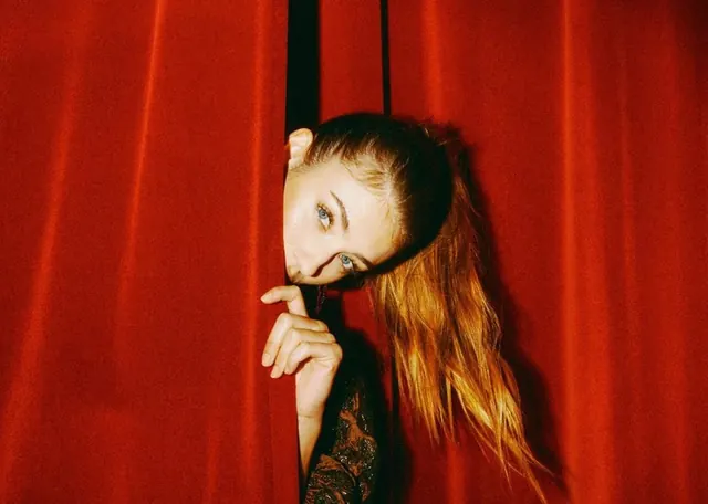 Portrait against saturated red background, photographic, minimalist, vibrant