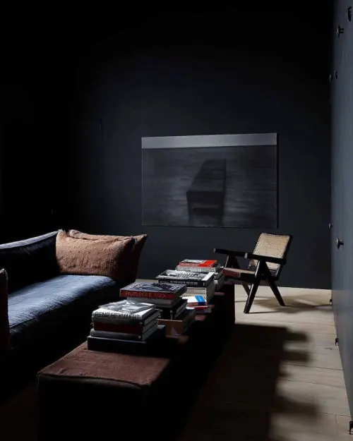 Minimalist interior with dark walls and stacked books, minimalist, photographic, dark