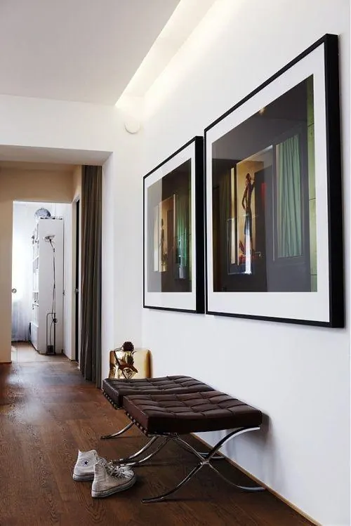 Minimalist hallway with framed art and bench, minimal, photographic, light