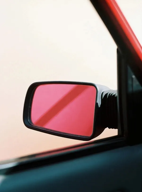 Car side mirror detail photograph, photographic, minimalist, warm