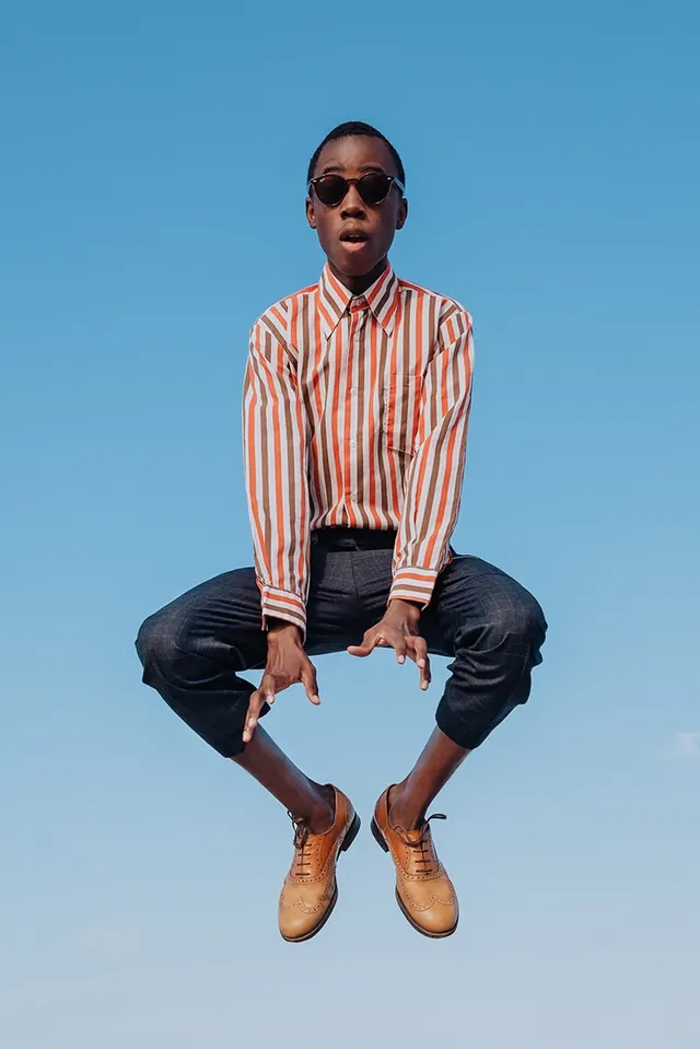 Portrait against bright blue sky, photographic, minimal, light