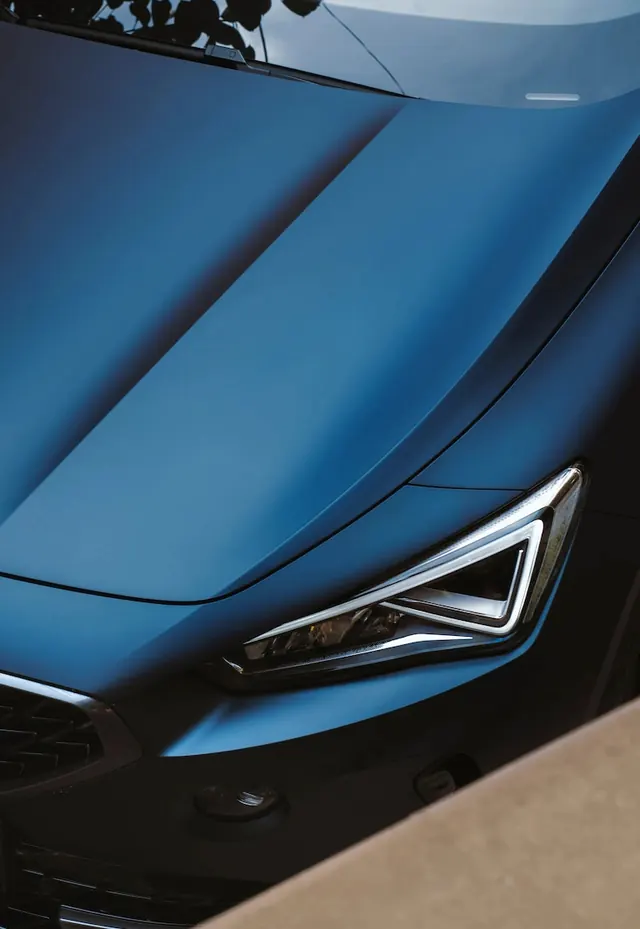 Blue vehicle headlight detail, photographic, minimalist, cool