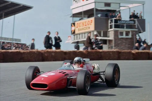 Vintage racing car at circuit, photographic, vibrant