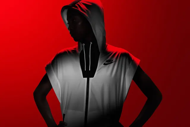 High-contrast figure against red background, high-contrast, dark-mode, dark