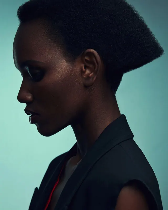 Profile portrait with teal background, photographic, minimalist, cool