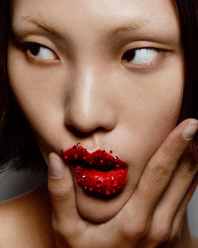 Red embellished lips close-up portrait, photographic, warm