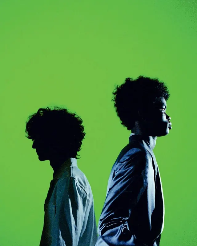 Back-to-back fashion portrait on green, editorial, photographic, vibrant