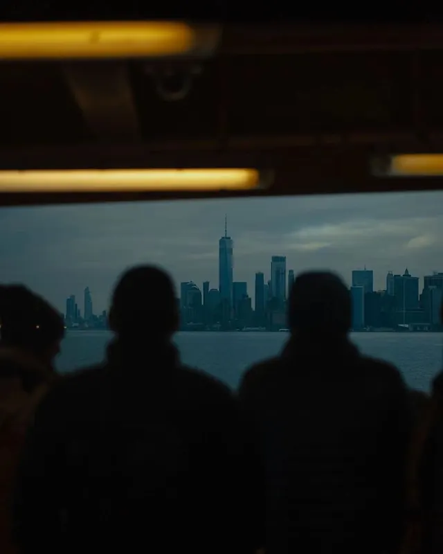NYC skyline from ferry interior, photographic, dark-mode, dark