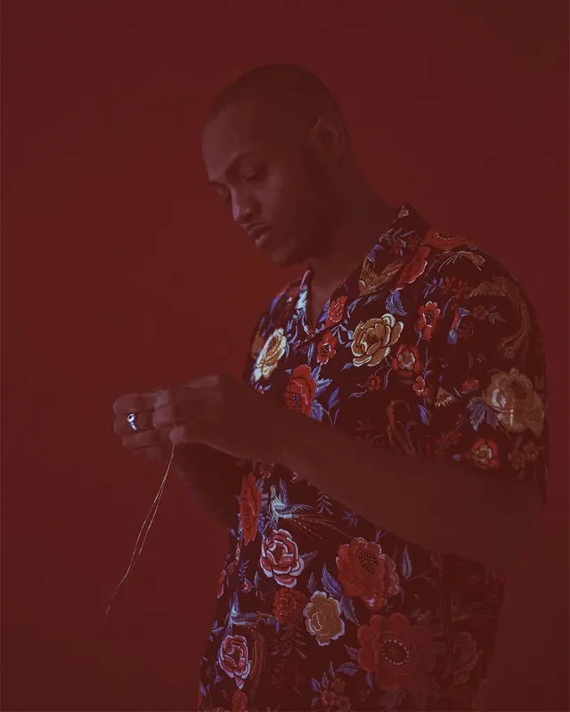 Red-lit floral shirt portrait, editorial, photographic, dark
