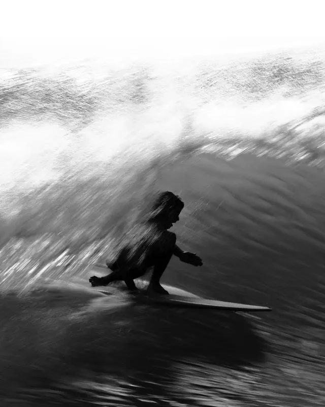 Motion-blur surfer in barrel, photographic, abstract, monochrome