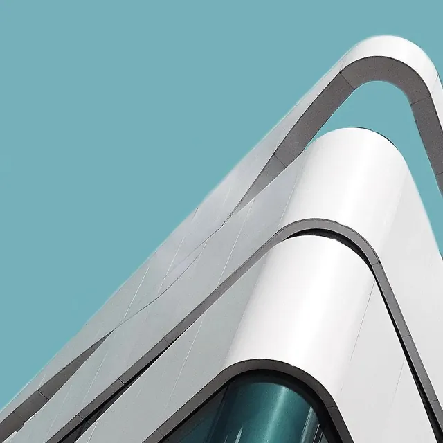 White curved architecture against teal sky, minimal, geometric, light