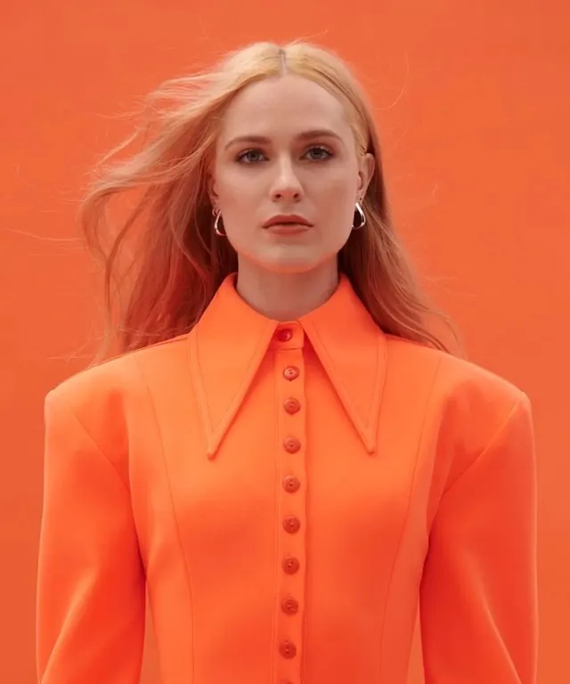 Orange-on-orange fashion portrait, minimal, editorial, vibrant