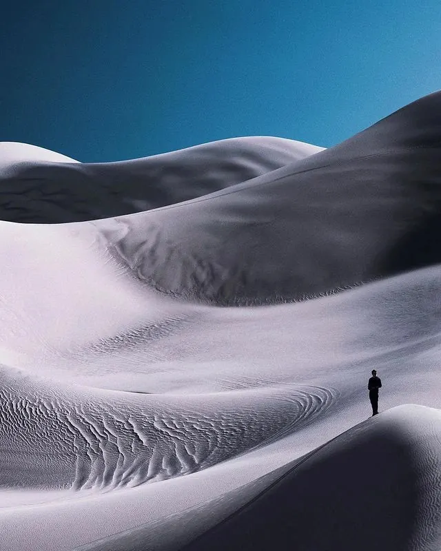 Lone figure on white dunes, minimal, photographic, light