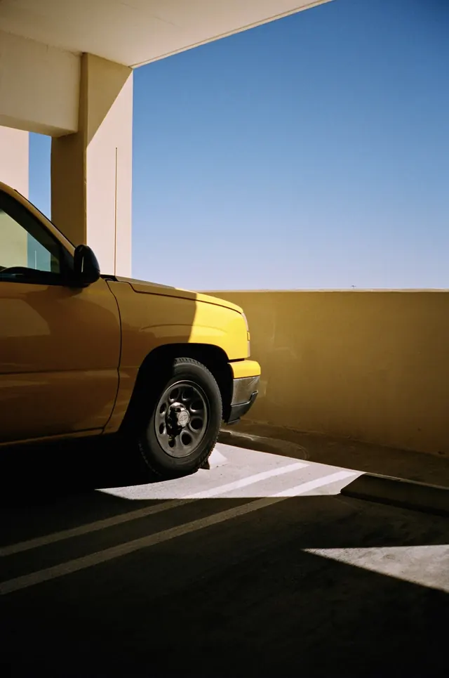 Yellow pickup in concrete garage, photographic, minimal, vibrant
