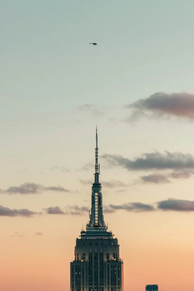 Empire State spire at sunset, photographic, minimal, warm