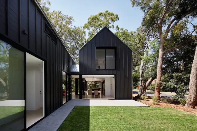 Black metal L-shaped modern house, minimal, photographic, dark