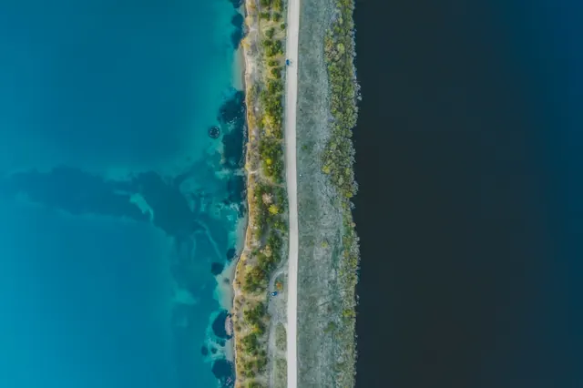 Aerial road between two waters, photographic, minimal, cool