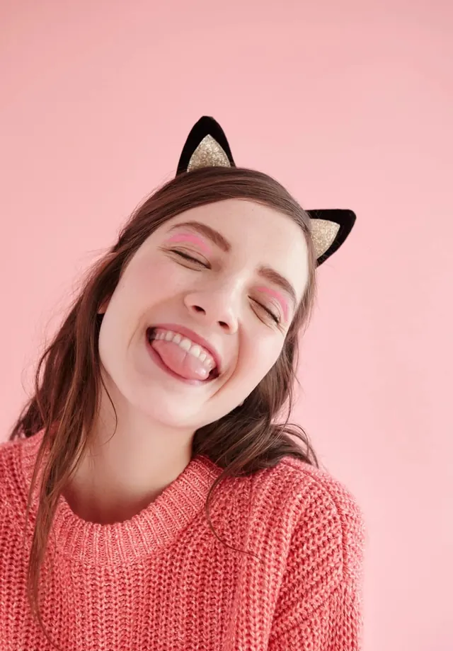 Pink studio portrait with cat ears, photographic, playful, pastel