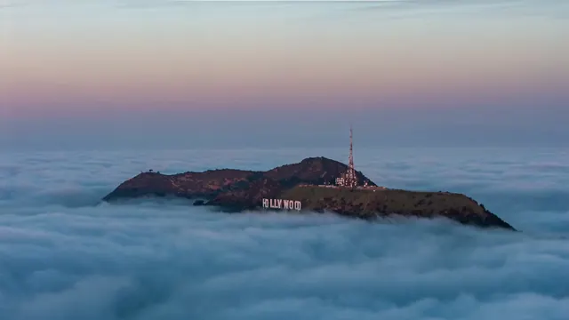 Hollywood Sign above fog sea at twilight, photographic, minimal, muted