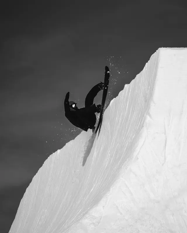 Monochrome snowboarder on halfpipe wall, photographic, minimal, monochrome