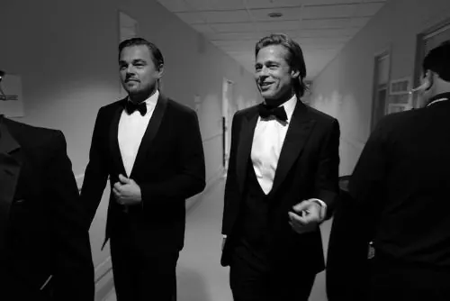 DiCaprio and Pitt tuxedo hallway candid, photographic, monochrome, monochrome