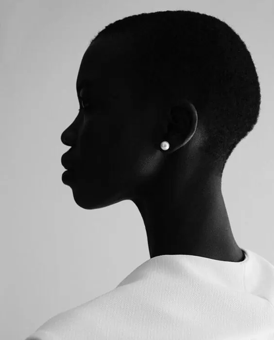 Minimalist profile portrait with pearl earring, minimal, photographic, monochrome